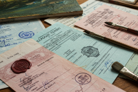 Export documents, stamps, and artist brushes on the table