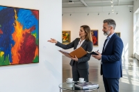 Experts in an art gallery evaluating a painting before submission to an international auction