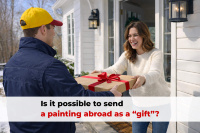 Courier in blue jacket and yellow cap hands over gift box with red ribbon to smiling woman against white house background in winter