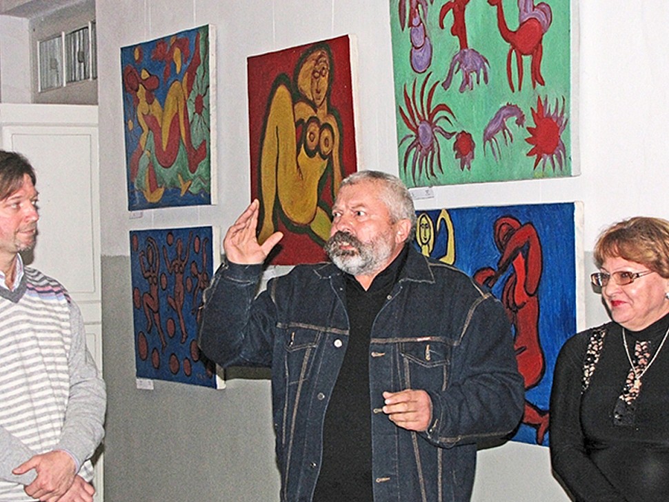 artist boiko peter on the background of paintings exhibition